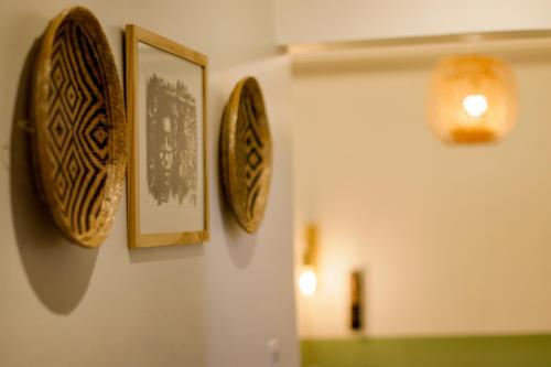 three plates hanging on a wall in a room at APTO prox UFAM, INPA e DISTRITO in Manaus