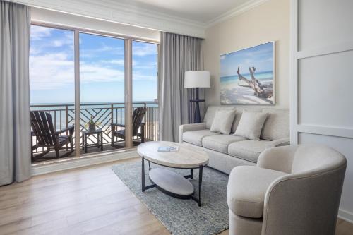 a living room with a couch and a table at Sandpearl Resort Private Beach in Clearwater Beach