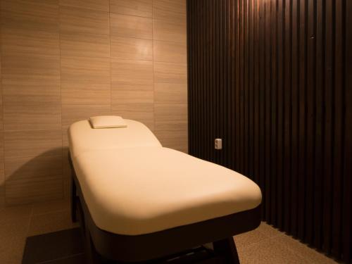 a hospital bed in a room with wooden walls at Park Hotel Asenevtsi in Veliko Tŭrnovo