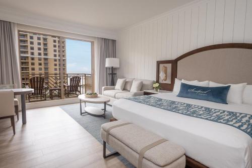 a hotel room with a large bed and a balcony at Sandpearl Resort Private Beach in Clearwater Beach