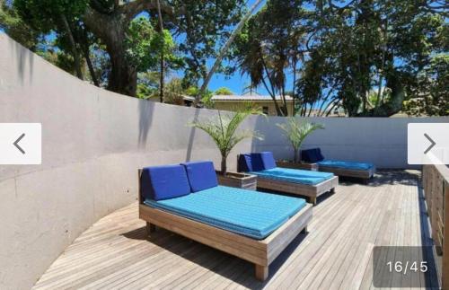 two blue lounge chairs sitting on a wooden deck at Banana Beach Club Unit A2 in Port Shepstone
