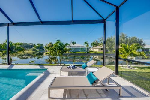 a view of the pool from the house at BRANDNEW Villa-PureSun at Canal intersection, heated saltwater pool and spa, facing south in Cape Coral