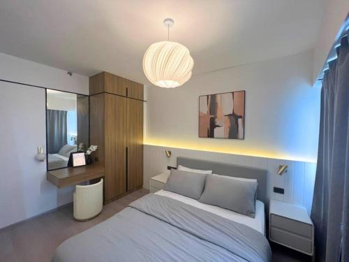 a bedroom with a white bed and a mirror at Modern Nordic 1 Bedroom Condo near Eastwood, Quezon City in Manila