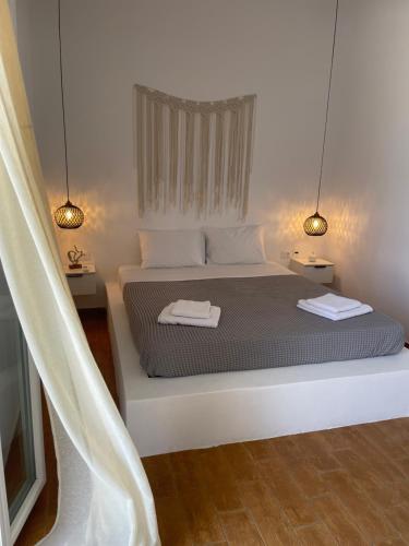 a bedroom with a bed with two towels on it at Sofianna's oasis in Kalloni Tinou