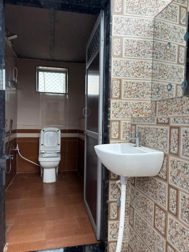a bathroom with a sink and a toilet at Hotel Raghunath Palace in Khātu