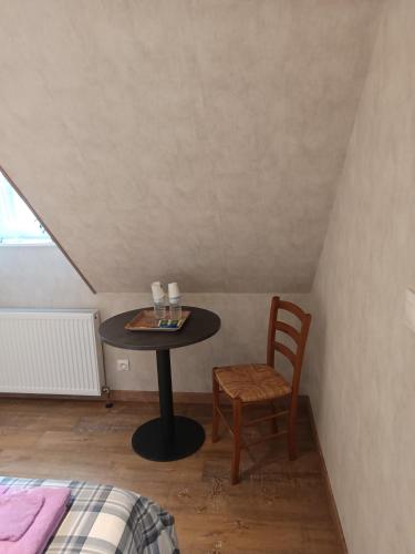 une petite table et une chaise dans une chambre dans l'établissement LA CLIMONTAINE BIS, à Urbeis