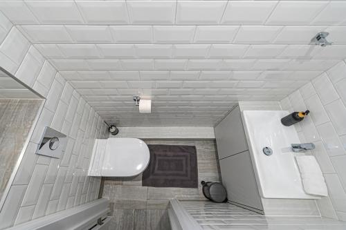 a bathroom with a sink and a toilet at Riverside 1 BD Central Apartment by Hostlovers in Kaunas