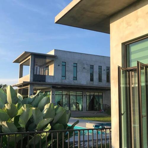 a large building with a cactus in front of it at U House Exclusive Retreat in Alor Gajah in Kampong Alor Gajah