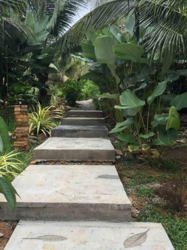 a row of steps in a garden with plants at U House Exclusive Retreat in Alor Gajah in Kampong Alor Gajah