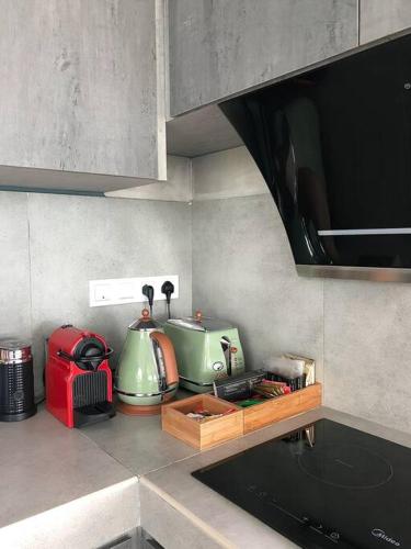 a kitchen with a counter with a toaster and a appliance at U House Exclusive Retreat in Alor Gajah in Kampong Alor Gajah