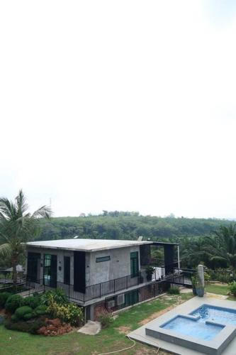 a house with a swimming pool in front of it at U House Exclusive Retreat in Alor Gajah in Kampong Alor Gajah