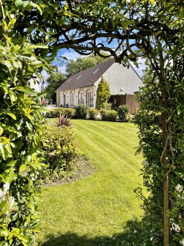 a house in a yard with a green lawn at The Old Mill Rooms in Yarm