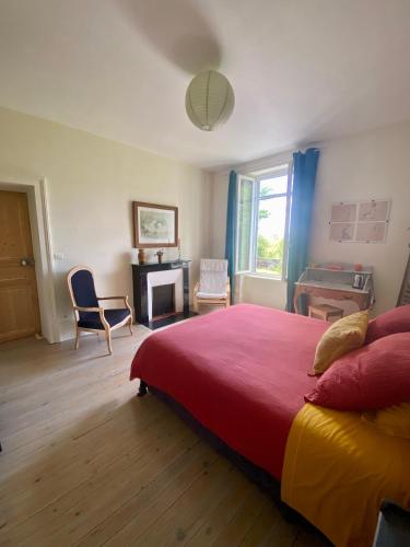 a bedroom with a bed and a desk and a chair at La Maison de l'Andelot in Monteignet-sur-lʼAndelot