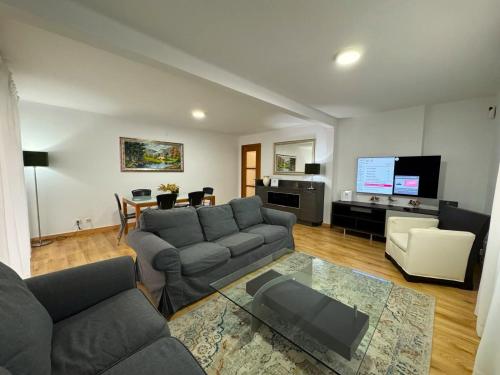 a living room with a couch and a flat screen tv at Alojamiento Barbastro in Salou