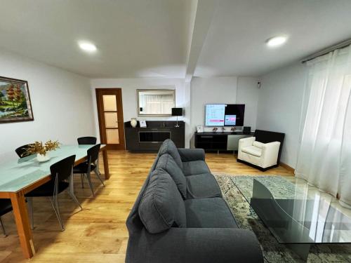 a living room with a couch and a table at Alojamiento Barbastro in Salou