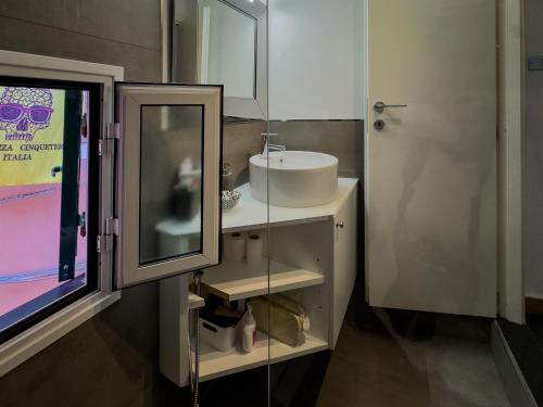 a bathroom with a sink and a mirror at La Maison de la Mer with Terrace and AC in Vernazza