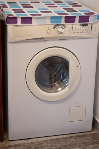 a washing machine with a bed on top of it at Villa & Stone House with Pool, 10 Mins to Skala Eressos Beach in Eresos