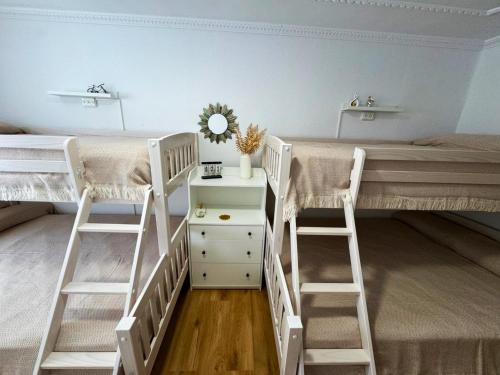 a room with two bunk beds and a desk at Alojamiento Barbastro in Salou