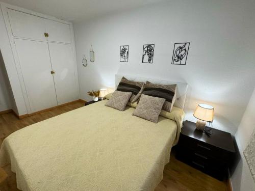 a bedroom with a large bed with two lamps at Alojamiento Barbastro in Salou
