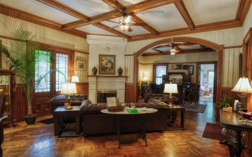 a living room with a couch and a fireplace at Rockwell Falls Inn and Wine Bar in Lake Luzerne