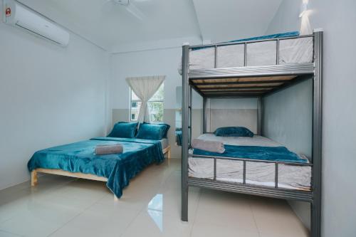 a bedroom with a bunk bed and a twin bed at Kings Pine Residence homestay 14 in Ranau