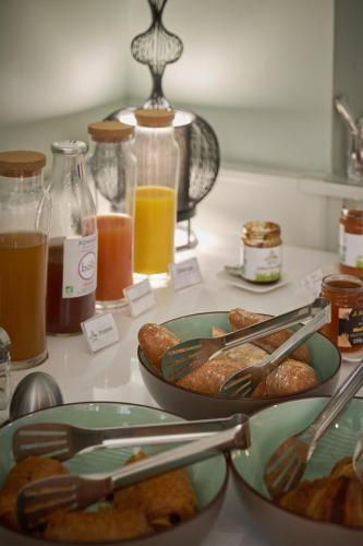 a table with plates of food on a counter at Hôtel du Château Bois Guibert in Bonneval