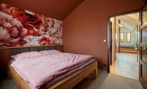 a bedroom with a large flower painting on the wall at Elysium in Kolín