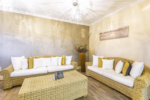 a living room with two couches and a table at Auas City Hotel in Windhoek