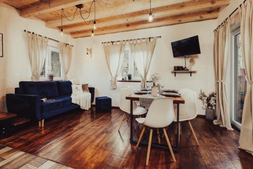 a living room with a blue couch and a table at Leśny Azyl Marózek in Maróz