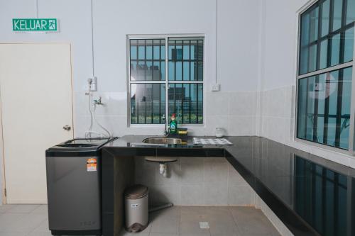 a bathroom with a sink and a mirror at Kings Pine Residence homestay 14 in Ranau