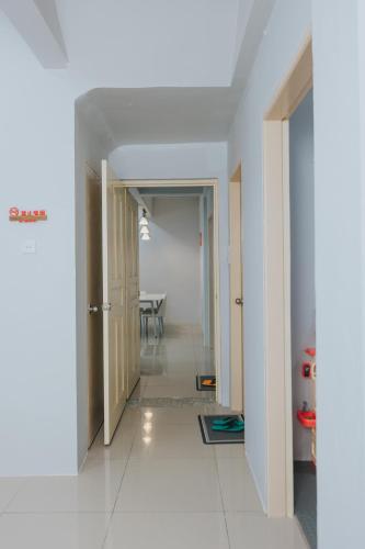 a hallway with a dining room and a table at Kings Pine Residence homestay 14 in Ranau