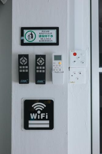 a wall with a wii controllers and signs on it at Kings Pine Residence homestay 14 in Ranau