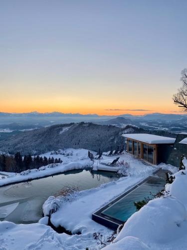 a house with a swimming pool in the snow at Gipfelhaus Magdalensberg in Sankt Veit an der Glan