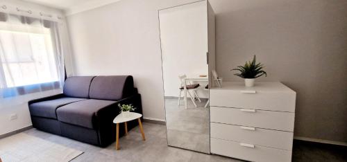 - une chambre avec un canapé, une commode et un miroir dans l'établissement 2 Le Saint Joseph studio in city center of Antibes with AC, à Antibes