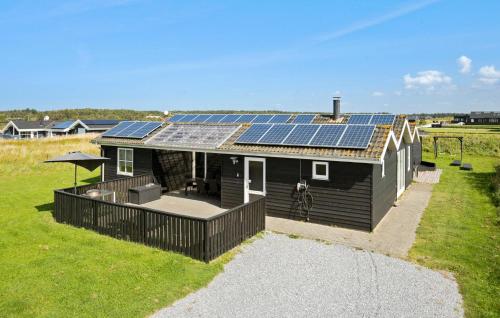 a house with solar panels on the roof at Nice Home In Løkken With Kitchen in Løkken