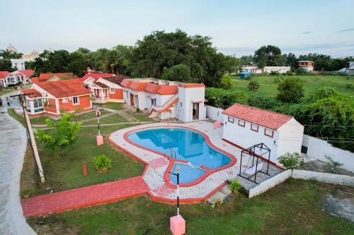 an aerial view of a house with a swimming pool at Mamalla Kudil Resort in Mahabalipuram