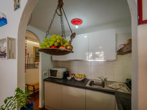 a kitchen with a bowl of fruit on the counter at La Maison de la Mer with Terrace and AC in Vernazza