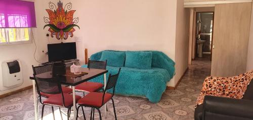 a living room with a blue couch and a table at Casa en uspallata in Uspallata