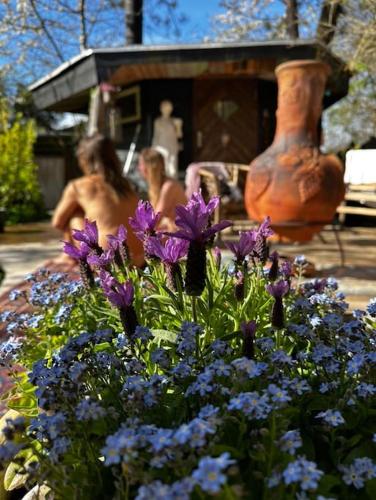 a group of people in a garden with purple flowers at Rågeleje's Oasis - Coastal Home with Wood Burning Sauna in Græsted