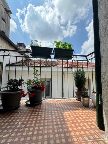 a balcony with potted plants on a building at Bricks House in Chieri