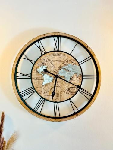 a clock with a map of the world on a wall at Bricks House in Chieri