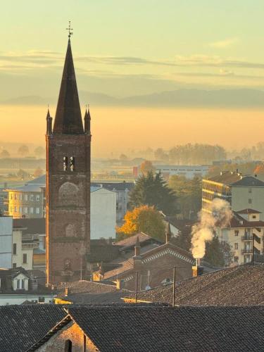a tall building with a clock tower in a city at Bricks House in Chieri