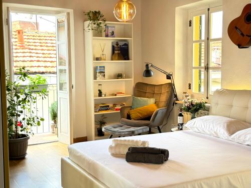 a bedroom with a bed and a chair and a window at Bricks House in Chieri