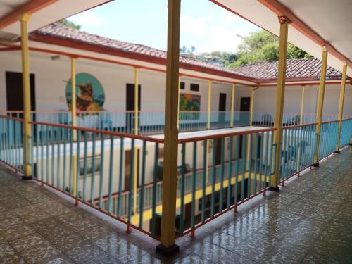 a building with a pool in front of it at Imca Hotel in Buga