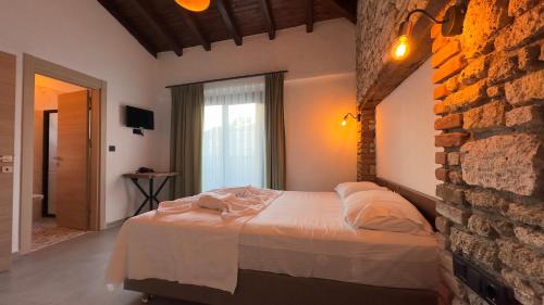 a bedroom with a bed and a brick wall at Mira House in Cesme