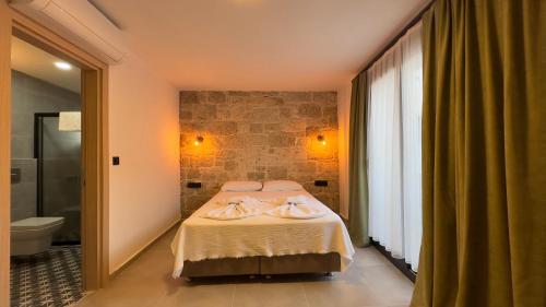 a bedroom with a bed with towels on it at Mira House in Cesme