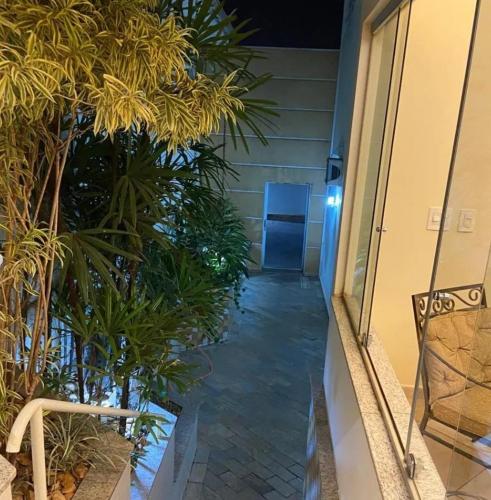 a hallway of a house with plants and a door at Pindorama Golden Plaza Hotel - Pindorama SP in Catanduva