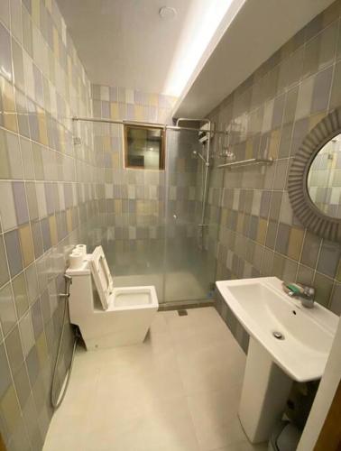 a bathroom with a shower and a toilet and a sink at Elle Casa is a modern-European inspired house coc in San Pablo