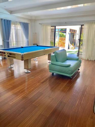 a living room with a pool table and a couch at Elle Casa is a modern-European inspired house coc in San Pablo