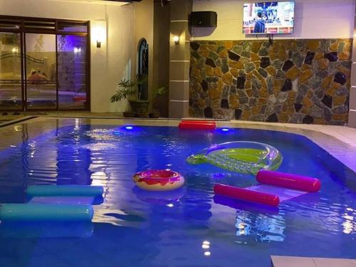 a pool with a water slide in a hotel at Elle Casa is a modern-European inspired house coc in San Pablo